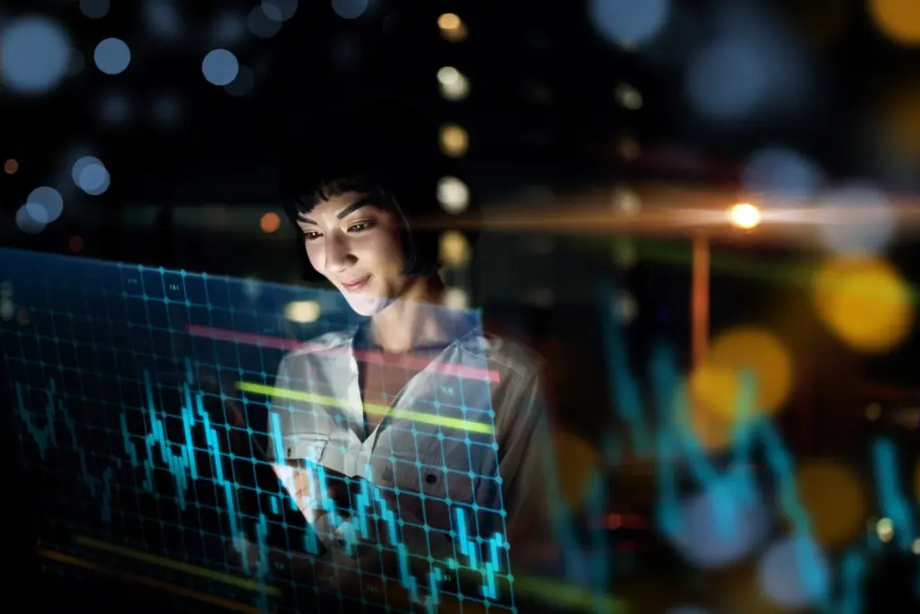 Frau analysiert Finanzdaten am Bildschirm – Financipation Club